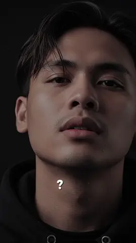 DARK PROMPT AI Prompt : A hyper-realistic extreme close-up portrait of an Indonesian man with a light olive skin tone. The camera angle is from slightly below, focusing upward on his chin, jaw, and face. His head is tilted slightly back, revealing his sharp jawline and masculine bone structure. The framing captures from his lower chin to his forehead, with a sharp focus on the micro-textures of his skin: visible pores, a light beard, and messy, side-parted strands of wet hair that fall naturally across his forehead. Realistic beads of sweat glisten on his neck, jaw, and cheekbones. His lips are slightly parted, his eyes half-closed with a soft, mysterious gaze, evoking the aura of a high-fashion editorial model. The lighting is dramatic yet colorful: a soft, directional flash from the bottom right highlights the contours of his jaw and cheekbones, while also casting deep, cinematic shadows. The background is completely dark to isolate the subject. This high-resolution, ultra-detailed, hyper-realistic editorial close-up portrait is full of color, with natural skin tones and rich, realistic textures. Black and white is not used.#trendai #prompt #creatorsearchinsights #imajinasi #aiprompt 