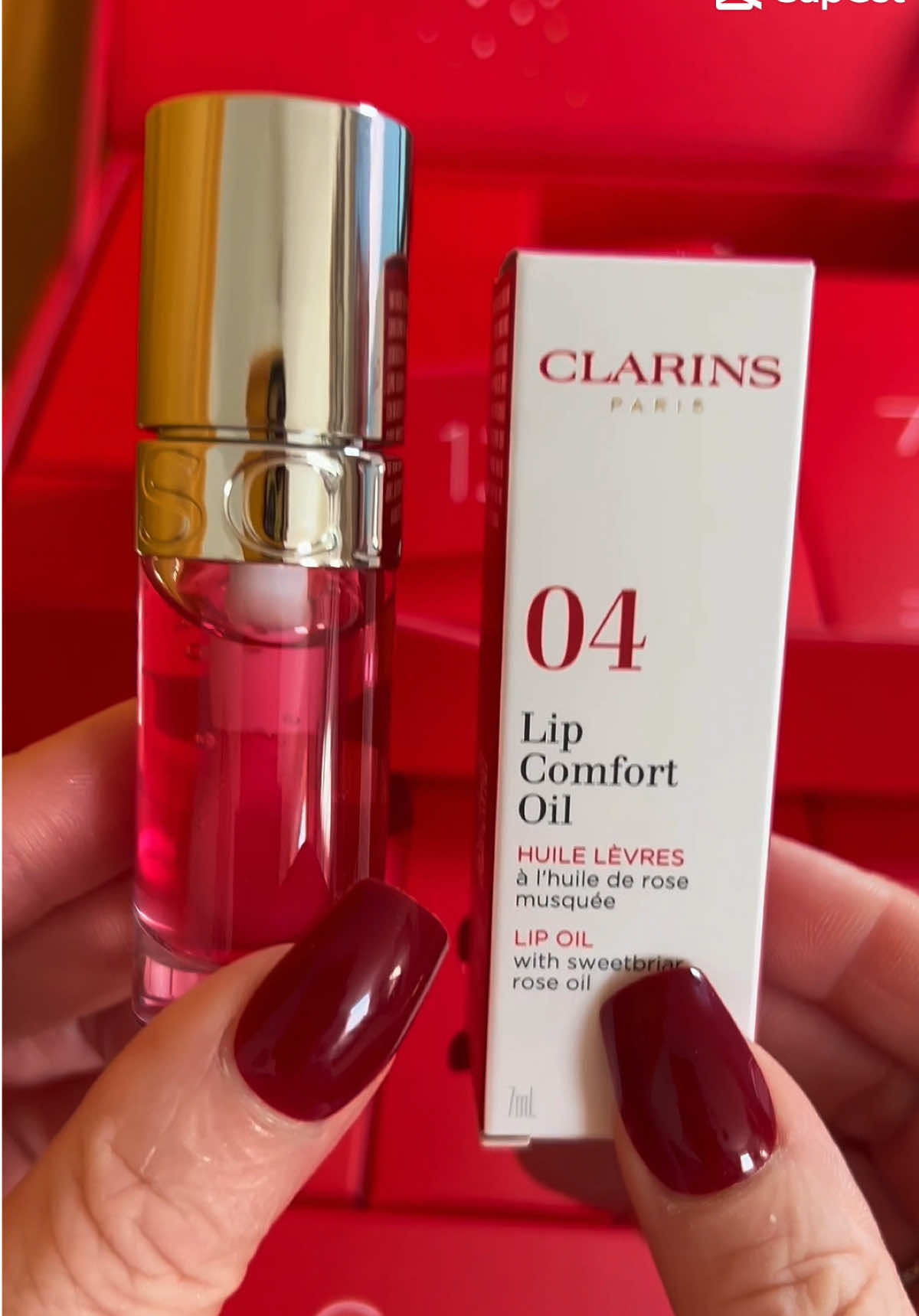 🎁 A closer look at one of the gorgeous treats from my Clarins 12-Day Advent Calendar ✨ This is the Clarins Lip Comfort Oil (04 Pitaya, 7ml) — a hydrating, high-gloss lip oil enriched with 93% natural ingredients like organic rose and jojoba oils 💧 It leaves lips nourished, smooth and glossy with a pop of pink 💋 I put my Clarins Collective gift voucher towards this and absolutely love it! 🌸 Join the Clarins Collective and enjoy 15% off £55+ when you shop through my link 💕 ➡️ https://collective.clarins.co.uk/a/sally #ClarinsCollective #ClarinsUK #Unboxing #ClarinsLipComfortOil @ClarinsUK 