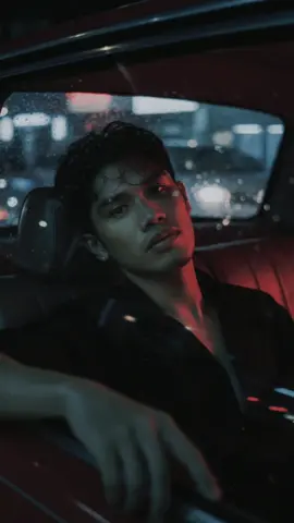 Gemini Al prompt Wong Kar-wai's cinematic-style realistic portrait Using an uploaded photo as a reference, highlighting the jawline and neck to create a statuesque look, while maintaining the shape and identity of the face. Pose: Sitting with his head against the window, his hand resting on the edge, the streetlight's light shining through. Setting: Inside an old taxi with faded leather seats, the glass fogged up by rain, and the streetlight's light refracting into blurred streaks. Camera angle: Shot from outside the window, with overlapping reflections on the face. Lighting: Red-green neon lights passing by, causing the face to change color with the light. Clothing: Black button-down shirt, slightly open, hair appearing damp. Image tone: Red-green contrast, thick film grain, pronounced motion blur, and a hazy glow around the vehicle's headlights. Mood: Loneliness, solitude, a sense of a big city with no answering voice.#CapCut 