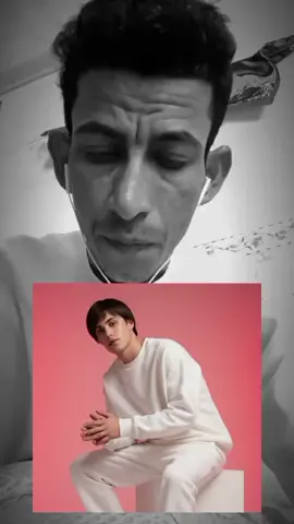 Stylish fashion editorial  photo of a male model wearing an oversized white sweatshirt and white sweatpants, paired with white sneakers. A soft red studio backdrop with soft cinematic lighting, highlighting textures, futuristic editorial style, model sitting elegantly, head slightly tilted, relaxed posture #الشعب_الصيني_ماله_حل😂😂 #طششونيي🔫🥺😹💞التخمط🌝💆🏻‍♀️🔫 #لايكات #هههههههههههههههههههههههههههههههههههههه 