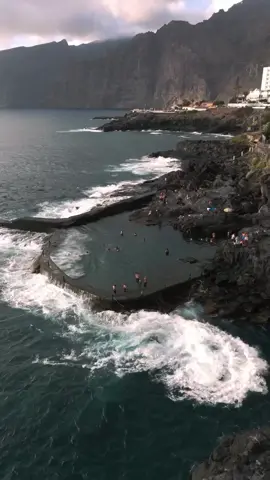 Los Gigantes Lava Pools, Spain 🇪🇸 On the coast of Tenerife, at the foot of the towering Los Gigantes cliffs, nature has sculpted something truly magical — natural lava pools filled with crystal-clear seawater. Formed by ancient volcanic eruptions, these rocky basins are sheltered from the pounding Atlantic waves, yet constantly refreshed by the ocean. Here, you can swim in calm turquoise waters while watching the dramatic cliffs rise above you — some of the tallest sea walls in Europe. It’s one of the island’s most unique ways to enjoy both the power and serenity of nature. #spain #tenerife #nature #travel #beautiful 