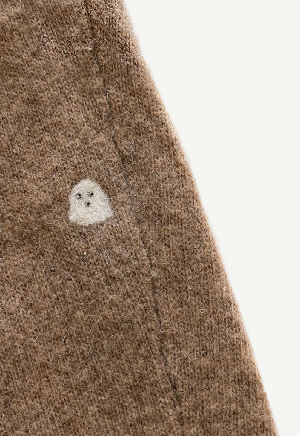 Needle felted ghost patch mending 👻 there’s really something to be said about something that is loved enough to be repaired. This needle felting method works best with natural fibers and knit items but I’ve also had great success using roving to mend other fabrics such as thicker cotton and denim! Instructions below. Instructions: Sew any large holes shut. Place your felting mat underneath the damaged area. Tear off small piece of white wool and roll into a loose ball. Place the wool over the hole and use your felting needle to stab the wool until the fibers compact and reduce in size. Refine the shape as you go. Use black or brown roving for the eyes Care: These repairs hold up well in the wash (cold wash, delicate cycle only) as long as the patch is *completely* felted. I recommend initially hand washing the mended area with warm water and a little bit of soap to ensure that the fibers have shrunken up enough and then you can wash carefully after that. #halloweendiy #mending #needlefelting #visiblemending #upcycledcrafts 