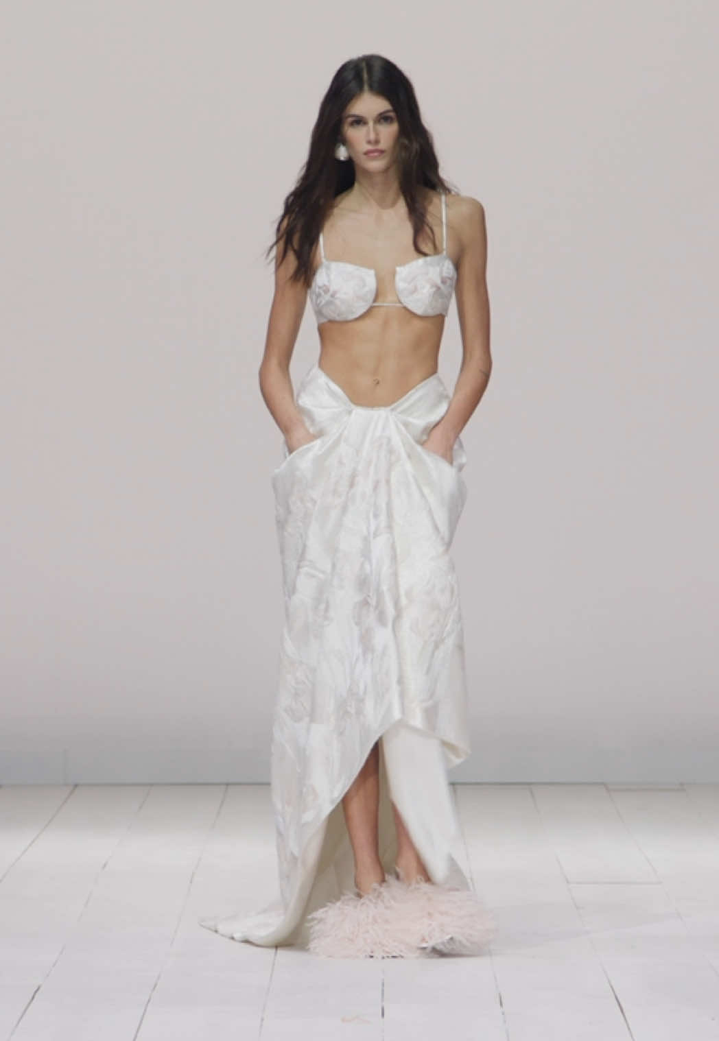 Kaia wears the cutaway bra and bed sheet skirt in calico duchesse satin with silk pink iris satin stitch embroidery.  #kaiagerber