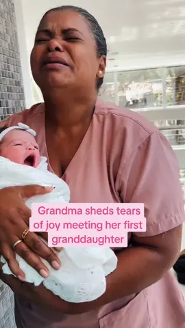 NICE TO MEET YOU!  Grandma sheds tears of joy meeting her first granddaughter