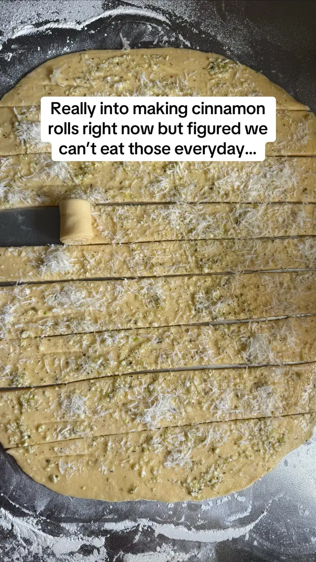 I thought this was a superior way to eat garlic bread and will 100% be doing this again (and again and again and again) DOUGH  🥛 180g warm milk (115°F) 🍞 2 1/4 tsp yeast (instant or active dry) 🍬 50g sugar 🧈 57g melted butter 🥚 1 egg + 1 yolk (room temp) 🌾 360g bread flour 🧂 ¾ tsp kosher salt * a little olive oil for the bowl (from ambitious kitchen) FILLING 🧈 57g butter, melted 🧄 5 cloves garlic, minced 🌿 1 Tbsp Italian seasoning 🧀 1 cup grated Parmesan HOW TO 1️⃣ Warm milk, add yeast + sugar → let it bloom if using active dry. DO NOT overheat the milk! 2️⃣ Add butter, eggs, flour & salt → mix & knead until soft and slightly sticky. 3️⃣ Oil a bowl, cover, and let rise 1–1½ hrs (till doubled). 4️⃣ Roll out to a 25×35 cm rectangle. 5️⃣ Mix garlic butter + seasoning, spread evenly, then sprinkle Parmesan. 6️⃣ Cut into 9 strips with a pizza cutter, roll each up, and place in a 9x9 pan. 7️⃣ Cover & rise again until they’ve doubled in size 8️⃣ Bake at 350°F for 18–23 mins. 9️⃣ Brush with butter, pull apart, and serve warm   #baking #homemadebread #garlicbread 