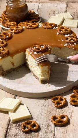 Salted Caramel Cheesecake ✨🤍 Silky white chocolate cheesecake over a pretzel graham cracker crust topped with homemade salted caramel sauce. 🤍 #saltedcaramel #cheesecake #caramelcheesecake #whitechocolate #fallbaking