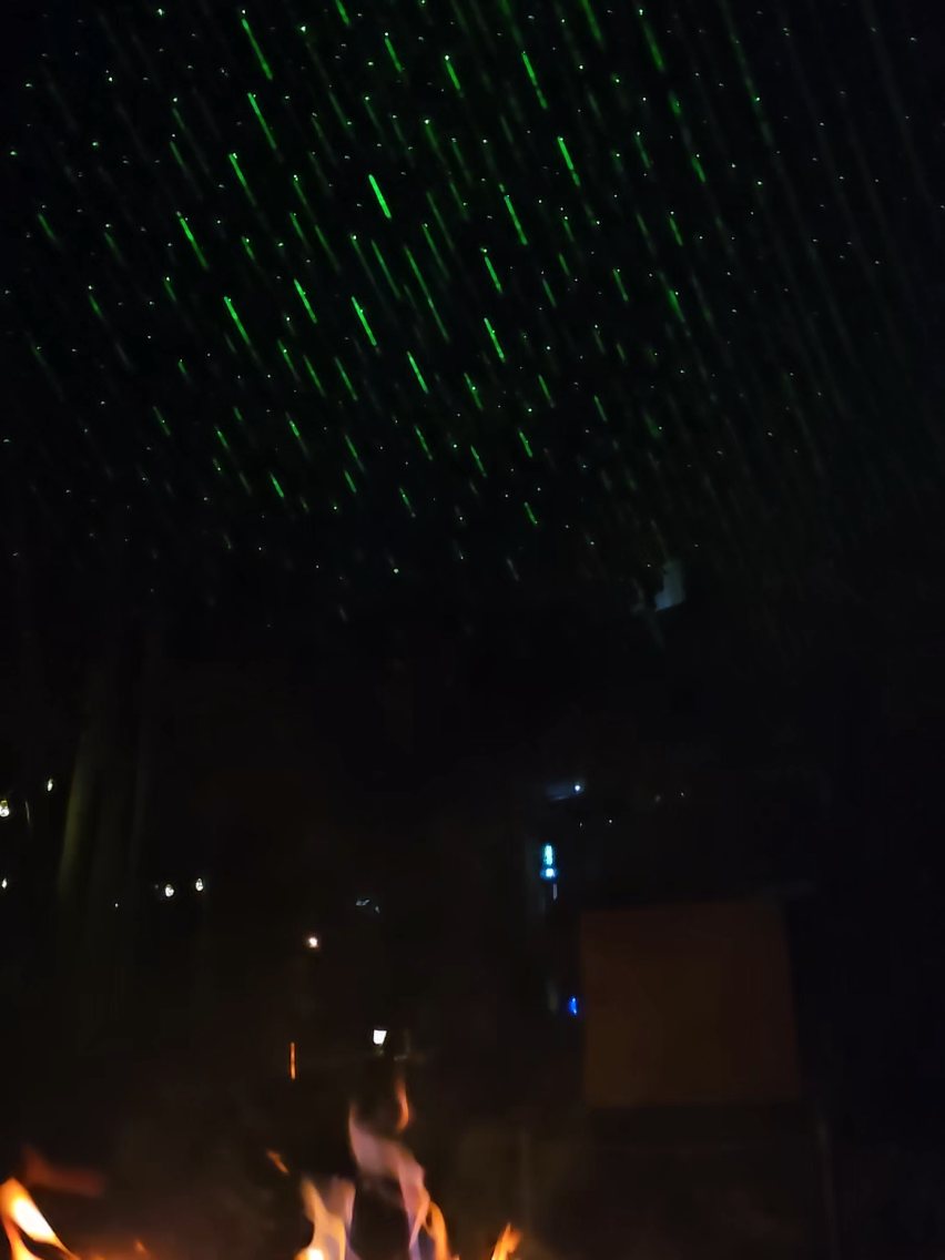 Cool little laser from Amazon shining on the trees. #backyardfirepit #fallvibes #laser 