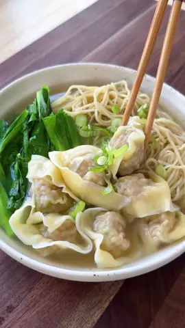 CANTONESE WONTON NOODLE SOUP | Episode 1: Dumplings Around the World 🥟🇭🇰 We’re off to Hong Kong for the ultimate comfort bowl: silky pork and prawn wontons floating in a savoury, clear broth! - 50 wonton wrappers Wontons Filling - 250g pork mince - 250g prawns, peeled, deveined, roughly chopped - 2 spring onions, finely chopped - ½ tsp sugar - ½ tsp salt - ½  tsp white pepper - 1 tbsp oyster sauce - 1 tsp chicken bouillon powder - 1 tbsp water - 2 tbsp cornstarch  Soup - 2L chicken stock, unseasoned - 2 tsp salt  - 4 spring onions, white part sliced - 2.5 cm piece ginger, sliced To Serve - Spring onion, thinly sliced - Hong Kong–style wonton noodles - Choy sum or baby bok choy Combine the pork mince, chopped prawns, spring onion, sugar, salt, white pepper, oyster sauce, chicken bouillon powder, water, and cornstarch in a large bowl. Mix well until sticky and cohesive, then cover and refrigerate for at least 30 minutes, or overnight for deeper flavour. When ready to wrap, place a wonton wrapper on your palm and add about a teaspoon of filling to the centre. Brush the edges with water, fold into a rectangle, then bring the two corners up to meet at the top and pinch to seal. Set aside on a tray and keep covered with a damp cloth to prevent drying. Bring the chicken stock to a boil in a large pot with the salt, spring onion whites, and ginger. Simmer for 10–15 minutes to infuse, then remove and discard the aromatics. Taste and adjust seasoning, keeping the broth warm over low heat. In a separate pot of boiling water, cook the wontons for 3–4 minutes or until they float. Remove with a slotted spoon, then cook the noodles and greens until just tender. Drain well. Divide the noodles, greens, and wontons among bowls. Ladle over about two cups of hot broth and top with sliced spring onion. Serve steaming hot. #Dumplings #Wontons #WontonNoodleSoup #HomeCooking #CantoneseFood    
