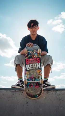Gemini AI PROMPT: 1. Open Gemini App/Website 2. Upload Your Photo 3. Copy & Paste this prompt: An Editorial-style- extreme close-up of A handsome young man stands confidently on the edge of the dystopian skatepark, holding a skateboard in front of her. Captured from a dramatic extreme low-angle ground-level perspective, the camera looks upward captures her skateboard is extremely close and massive in the frame, while her face remains in sharp focus. The skateboard filling the frame. He gazes downward toward the camera with a cool, self-assured expression. He has comma ark hair and slightly messy from the wind, with subtle strands catching the sunlight. Her outfit is bold and fashion-forward streetwear: a oversized navy jersey, light gray denim shorts cargo and Vans sk8 sneakers with colorful striped socks peeking out. he skateboard, leaning upright against her legs, features a colorful, detailed design with logo 