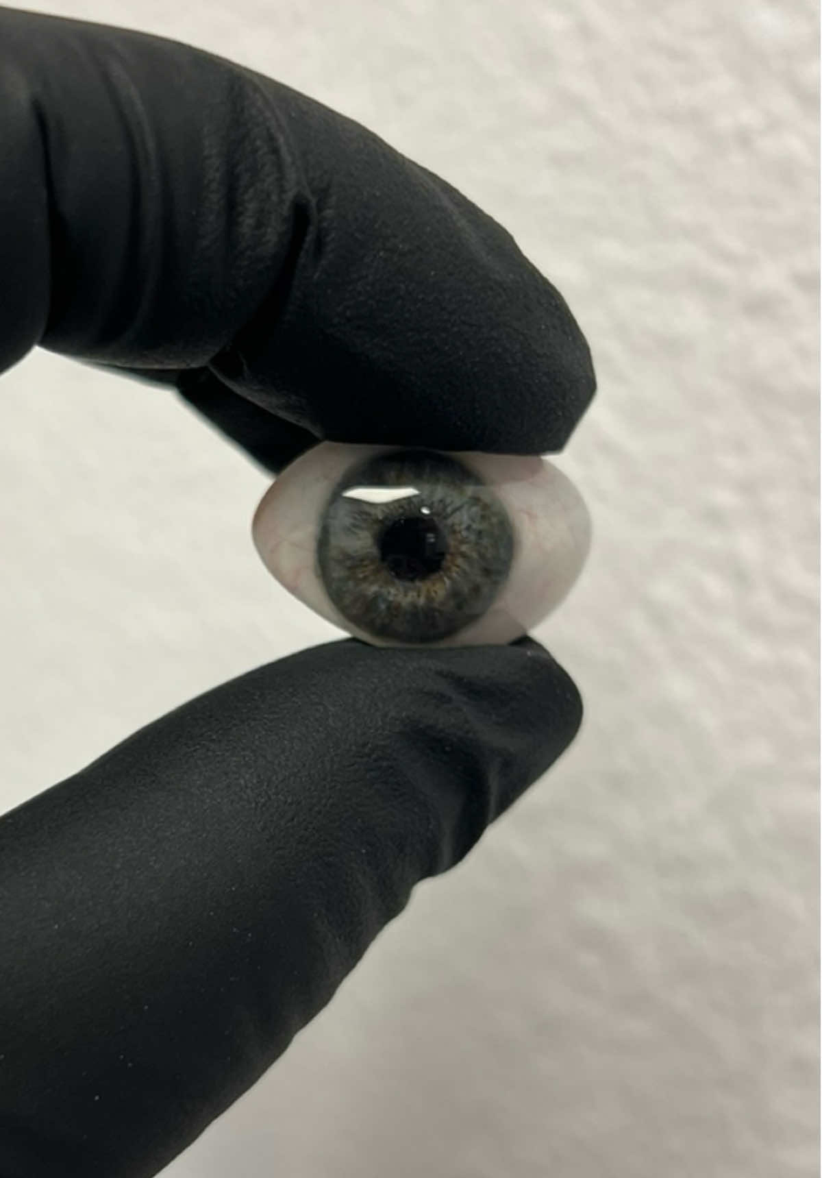 Clever ways to use a button in a space with limited fornices in an eye.  Instead of compromising the gaze, shave off the iris and paint it at a different angle on the white layer. That way you can still achieve the same angle and gaze as the other eye. #thinksmarternotharder #troubleshooting #ocularist #eyeseeyou #paintingtips 
