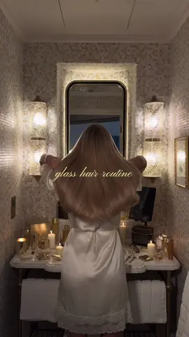 glass hair routine ✨✨ using:                                                                                     ….                                                                    @Gisou honey gloss shampoo & milk styling cream.                                                  @Kérastase gloss absolu insta glaze  & glaze drops                                                 @Augustinus Bader scalp serum  @Dyson UK air wrap  #glasshair #showertok #girlythings #hairroutine #haircare 