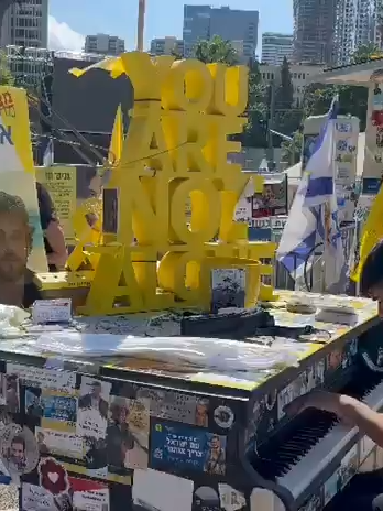 Across Israel, pianos fill public squares with songs of hope: melodies for Alon Ohel, the gifted young pianist still held in Hamas captivity. As we await his return, every note carries a prayer: that he will once again see light, touch the keys, and play freely. May this music reach him, wherever he is, a reminder that he is not forgotten. 📸: Hostage Families Forum