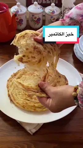 وضعت نصف الكمية في الفريزر 😉 من الآن فصاعداً سأعدّها دائماً بضعف الكمية ✅ 🌿🌿🌿 **المكونات المطلوبة:** * كوبان من الحليب بدرجة حرارة الغرفة * كمية من الدقيق (أضفوا حتى يتماسك العجين — بعد 4 أكواب أضيفوا بشكل متحكم) * ملعقة شاي ممسوحة من الملح 🌿🌿🌿 **للحشوة (الطبقات):** * 160 غرام من الزبدة * أكثر قليلاً من نصف كوب زيت نباتي * ملعقتان كبيرتان ممسوحتان من الدقيق 🌿🌿🌿 تُخلط جميع مكونات العجين وتُعجن حتى تصبح لا صلبة ولا لينة جداً، ثم تُترك لترتاح 10 دقائق. 🌿🌿🌿 بعدها تُقسم العجينة إلى 8 كرات وتُترك لترتاح 10 دقائق أخرى. 🌿🌿🌿 تُذاب الزبدة ويُضاف إليها الزيت والدقيق ويُخلط جيداً. 🌿🌿🌿 تُفرد كرة من العجين، ويُسكب عليها خليط الزبدة، ثم تُفرد كرة أخرى وتُوضع فوقها، وتُدهن مجدداً بالزبدة، وتُطوى كما هو موضح في الفيديو، مع دهن الزبدة بين الطبقات أثناء الطي. 🌿🌿🌿 بعد الانتهاء من جميع الكرات، تُترك في الثلاجة 10 دقائق. ثم تُقطع الكرات من المنتصف وتُفرد مجدداً. 🌿🌿🌿 تُطهى في مقلاة ساخنة، عند تحمير الوجه الأول تُقلب على الجانب الآخر، ثم تُعاد للقلب مرة أخرى ويُضغط عليها بخفة لتصبح طرية جداً — هذه الخطوة مهمة للحصول على كاتمير هش ومفصول الطبقات. يجب أن تكون النار متوسطة الحرارة 😉 شهية طيبة لكل من يجربها، مع المحبة 🌸 --- ### 🇬🇧 **English Translation:** Try katmer this way ✅ English recipe in the comments 👇 I put half of it in the freezer 😉 From now on, I’ll always make a double batch ✅ 🌿🌿🌿 **Ingredients:** * 2 cups milk (room temperature) * As much flour as needed (add carefully after 4 cups) * 1 level teaspoon salt 🌿🌿🌿 **For the filling (between the layers):** * 160 g butter * A little more than half a cup of oil * 2 level tablespoons flour 🌿🌿🌿 Combine all dough ingredients and knead until the dough is neither too hard nor too soft. Let it rest for 10 minutes. 🌿🌿🌿 Divide the dough into 8 balls and let rest another 10 minutes. 🌿🌿🌿 Melt the butter, add oil and flour, and mix well. 🌿🌿🌿 Roll out one ball of dough, drizzle it with the butter mixture, then roll out another ball and place it on top. Brush again with butter and fold it as shown in the video, spreading butter between the folds. 🌿🌿🌿 After finishing all pieces, refrigerate for 10 minutes. Cut each piece in half and roll it out again. 🌿🌿🌿 Cook on a preheated pan. When one side is cooked, flip it over. Then flip again and gently press to keep it soft — this step is crucial for getting flaky layers. Keep the heat on medium 😉 Enjoy it, everyone! With love 🌸