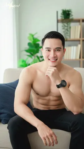 #แจกpromptฟรี #แต่งรูปผู้ชาย #แต่งภาพAIล่าสุด #AIแต่งรูป ❤️ fallows me : Photorealistic portrait of a handsome young Thai man in his early 20s, muscular and fit body, shirtless, sitting cross-legged on a beige couch in a cozy room, he is smiling warmly at the camera, one hand resting on his chin, wearing loose black jeans and a black digital watch, a dark blue pillow is next to him, soft natural window lighting, high detail, 8K, sharp focus