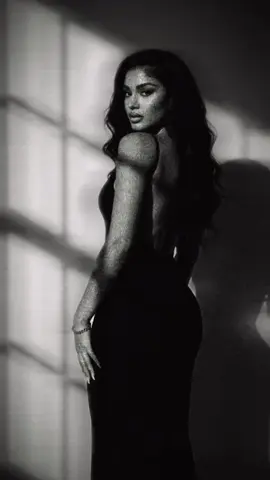 1. Open Gemini 2. Upload image 3. paste the promt prompt: Without changing my face. Put me in a long black dress, with a wall behind me with the shadow of a window showing. The black dress should fall all the way down to my feet. Fitting very tightly showing my curves and have my back showing. My hair should fall in long waves. Have me wearing a gold bracelet. My hands to fall down my sides, and I will be looking back at the camera. Nails should be almond French tip nails. #geminiai #trend #photoshoot #fyp #ai 