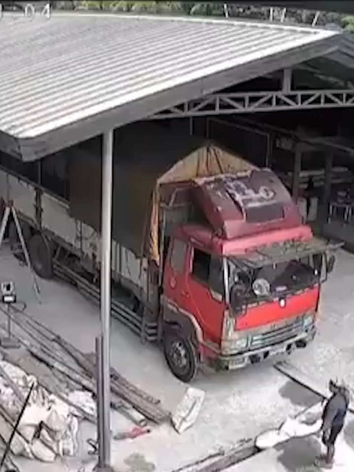 Video shows a red truck in a workshop during a 7.4 magnitude earthquake off the Philippines on Oct 10, 2025. The ground shakes intensely, but the structure holds. People are seen reacting to the quake. #Earthquake #Philippines.