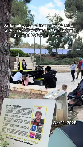 An Israeli police officer plays Alon’s yellow piano on the night before his return IYH
