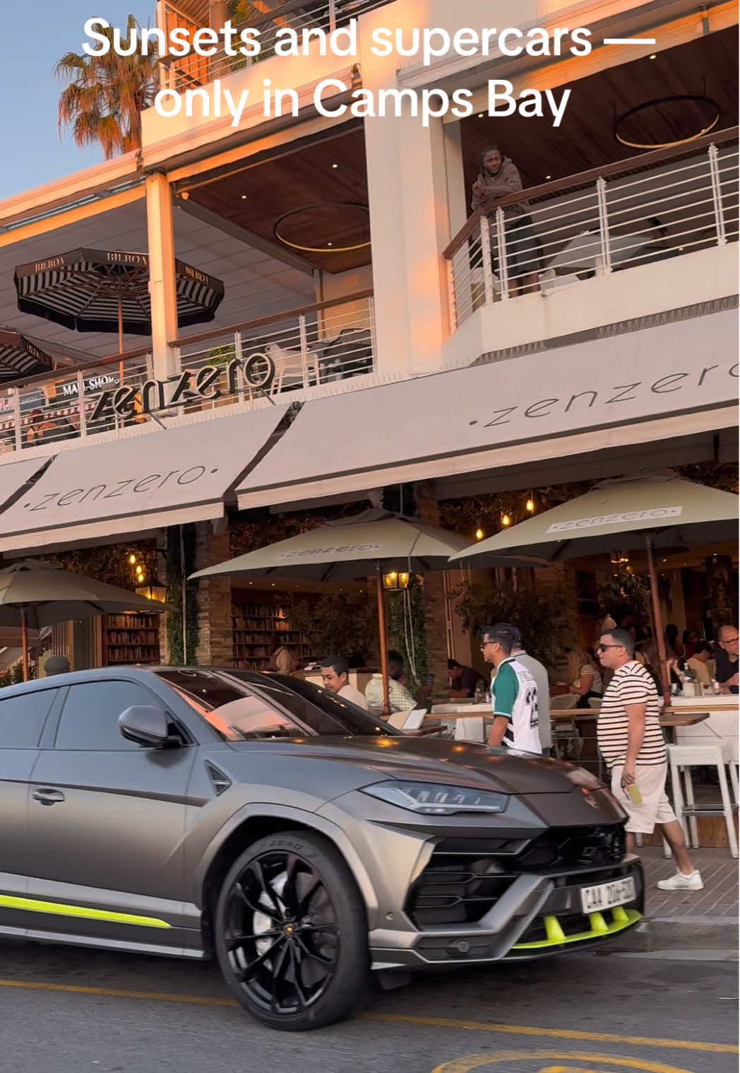 Camps Bay, Cape Town. Porsche 911, G Wagon, and not one but two Lamborghini Urus lined up along the strip as the sun hits the ocean.  Supercars, sunsets, and the Cape Town vibe in full swing. 🇿🇦  #CampsBay #CapeTown #Supercars #Porsche911 #LamborghiniUrus    