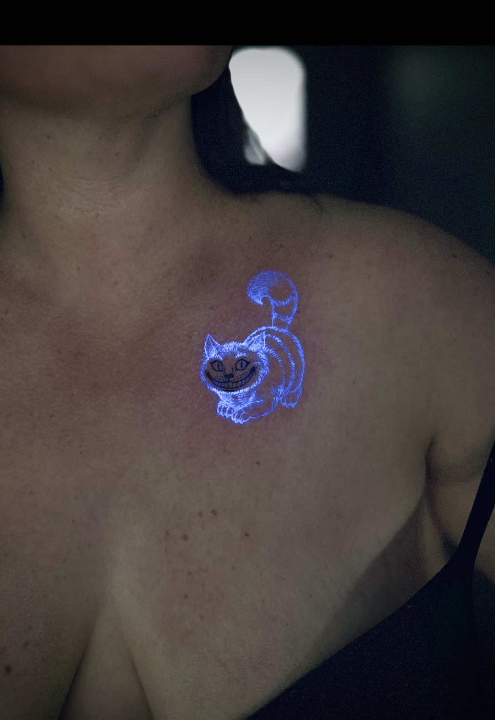 🐱 ✨ One more Cat added to the “Cheshire” family 🐈 🐈‍⬛  For booking enquiries: ─── ⋆⋅ ♰ ⋅⋆ ─── Instagram DM: @theministryofink Email: the.ink.minister@gmail.com Website: https://linktr.ee/InkMinister #uvtattoo #uv #blacklightart #glowinthedark #aliceinwonderland     