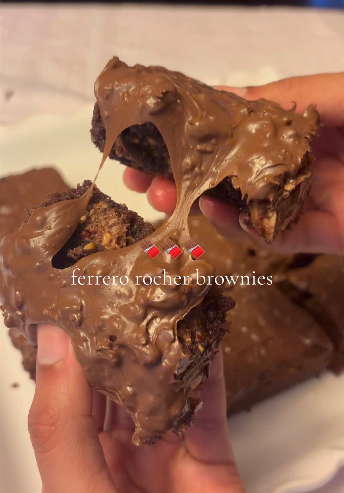 Ferrero rocher brownies with Nutella frosting🍫❤️😭 Ingredients - 1 cup (225 g) unsalted butter - 1 1/4 cups (200 g) dark chocolate, roughly chopped - 1 teaspoon vanilla extract - 1/3 cup (75 g) packed light brown sugar - 3/4 cup (150 g) granulated sugar - 3 large eggs - 3/4 cup (100 g) all-purpose flour - 2 tablespoons unsweetened cocoa powder - 8-9 ferrero rocher chocolates, chopped (or more if desired) - Optional: chocolate chips/chopped chocolate  Frosting: - 3/4 cup Nutella - 4-5 ferrero rocher chocolates, chopped finely Directions - Preheat the oven to 350 F. Line a 8x8 baking pan with parchment paper. - In a heatproof bowl, set it over a pot of simmering water, melt the butter and 1 1/4 cups dark chocolate together, stirring until smooth. Remove from heat and let cool slightly. - In a separate large bowl, beat the eggs, vanilla, brown sugar, and granulated sugar until pale, thick, and doubled in volume. I like to whisk it until I can no longer feel the granulated bits of sugar in the mixture. - Slowly whisk the cooled chocolate mixture into the egg mixture until fully incorporated. - Sift in the flour and cocoa powder and gently fold until just combined. - Gently fold in the chopped ferrero rocher chocolates and chocolate chips (if using). - Pour the batter into the prepared pan and smooth the top. Bake for 25–32 minutes, or until the edges are set and the center has a slight wobble. - Let the brownies cool completely in the pan before lifting out and slicing into squares. - To make frosting: mix the nutella and finely chopped ferrero rocher chocolates, and spread on top of the cooled brownies. If Nutella is too thick, you can slightly melt it in the microwave. #bakingszn #nutella #brownies @Ferrero Rocher USA 