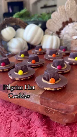 Pilgrim Hat Cookies!🦃🍪 Super easy and adorable! Perfect kids Thanksgiving treat, but to be real I’d eat these too! 😋  Ingredients:  Fudge Stripe Cookies Miniature Dark Reese’s Cups  Peanut Butter  Mini M&Ms (pick out the orange, yellow, red)  Directions:  1. Spread a little peanut butter around the hole on the bottom of a cookie.  2. Unwrap Reese’s cup, and place upside down onto the peanut butter. This should look like a hat band.  3. Place one mini m&m onto the peanut butter hat band for decoration.  #EasyRecipes #thanksgivingfood #thanksgivingideas #thanksgivingtreats 