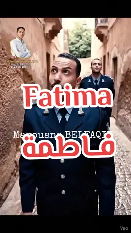 Detailed shot: Moroccan alleyway. Day. Two police officers stand on worn cobblestones. A woman on a second-floor balcony looks down. Action 1: Officer 1 speaks directly to the woman. Camera stays on him, medium shot, slight upward angle. Dialogue: 