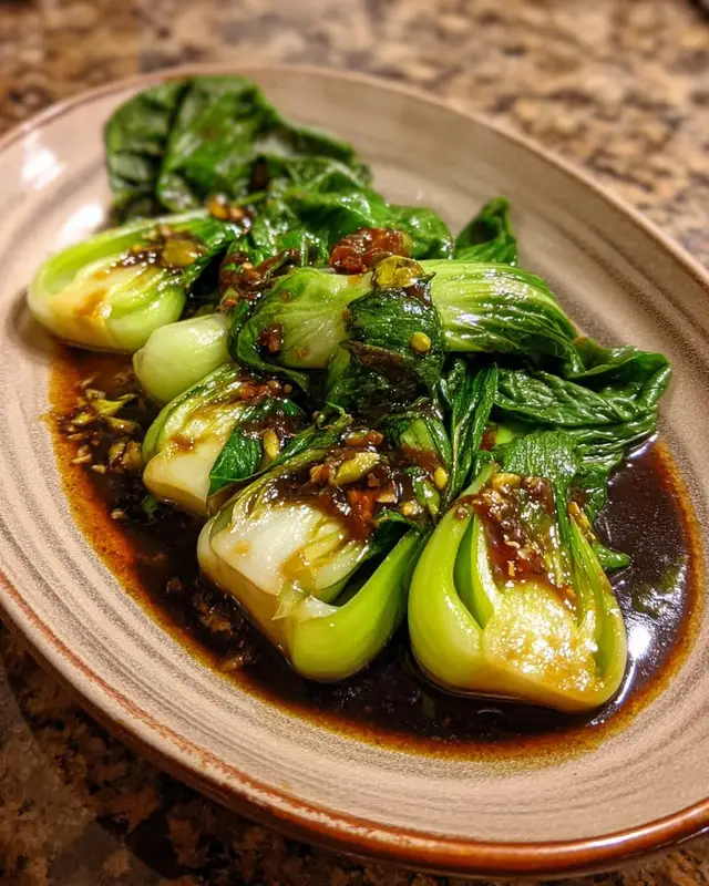 Bok Choy with Garlic Sauce Ingredients: 1 lb (450 g) baby bok choy, halved lengthwise 2 tbsp (30 ml) vegetable oil 3 cloves garlic, minced (9 g) 2 tbsp (30 ml) soy sauce 1 tbsp (15 ml) oyster sauce 1 tbsp (15 ml) rice vinegar 1 tsp cornstarch mixed with 2 tbsp water Salt & pepper, to taste Directions: Blanch bok choy in boiling water for 1–2 minutes, then drain and set aside. In a pan, heat oil and sauté garlic until fragrant. Add soy sauce, oyster sauce, and rice vinegar. Stir in cornstarch slurry and cook until sauce thickens. Add bok choy to the pan and toss gently to coat. Serve warm as a side dish. Prep Time: 10 minutes Cooking Time: 10 minutes Total Time: 20 minutes Kcal: 120 per serving Servings: 4#foryoupage ##christainpage #goviral 