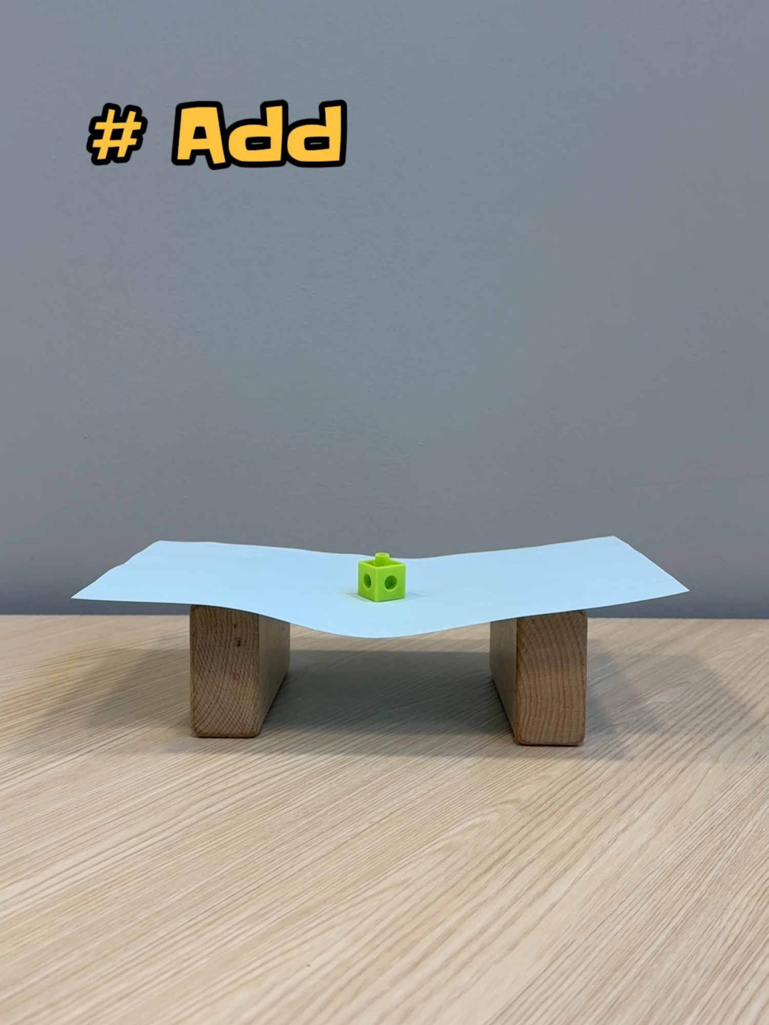 Can paper really hold weight? ⚖️ We put it to the test! 💪 How many cubes do you think this paper bridge can hold? 🤔 #ScienceForKids #PlaytoLearn #CambridgePreschool