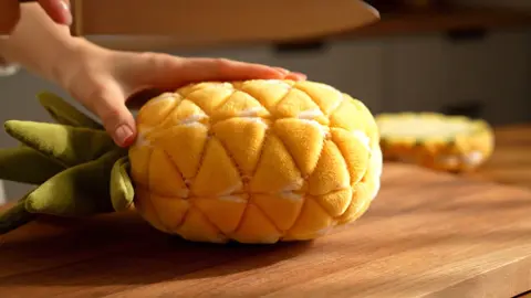 Witness the mesmerizing, slow-motion slicing of a plush pineapple sculpture, creating a calming sensory experience. #ASMR #PlushArt #SatisfyingCuts
