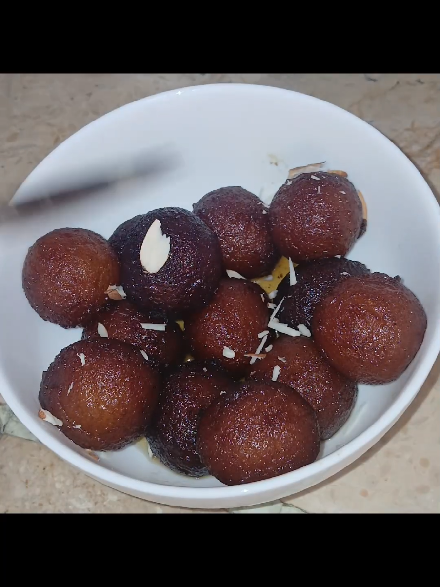 Gulab Jamun Ingredients - 1/2 cup milk - 1 tablespoon sugar - 1 tablespoon all-purpose flour - 1/4 teaspoon baking soda - 1/4 teaspoon salt - Ghee or oil for frying - Sugar syrup  Sugar Syrup - 1 cup sugar - 1 cup water - 1-2 cardamom pods Instructions 1. Mix milk, sugar, flour, baking soda, and salt to form a smooth dough. 2. Shape into small balls. 3. Fry the dumplings until golden brown. 4. Prepare sugar syrup by boiling sugar, water, and cardamom. 5. Soak the fried dumplings in the sugar syrup.