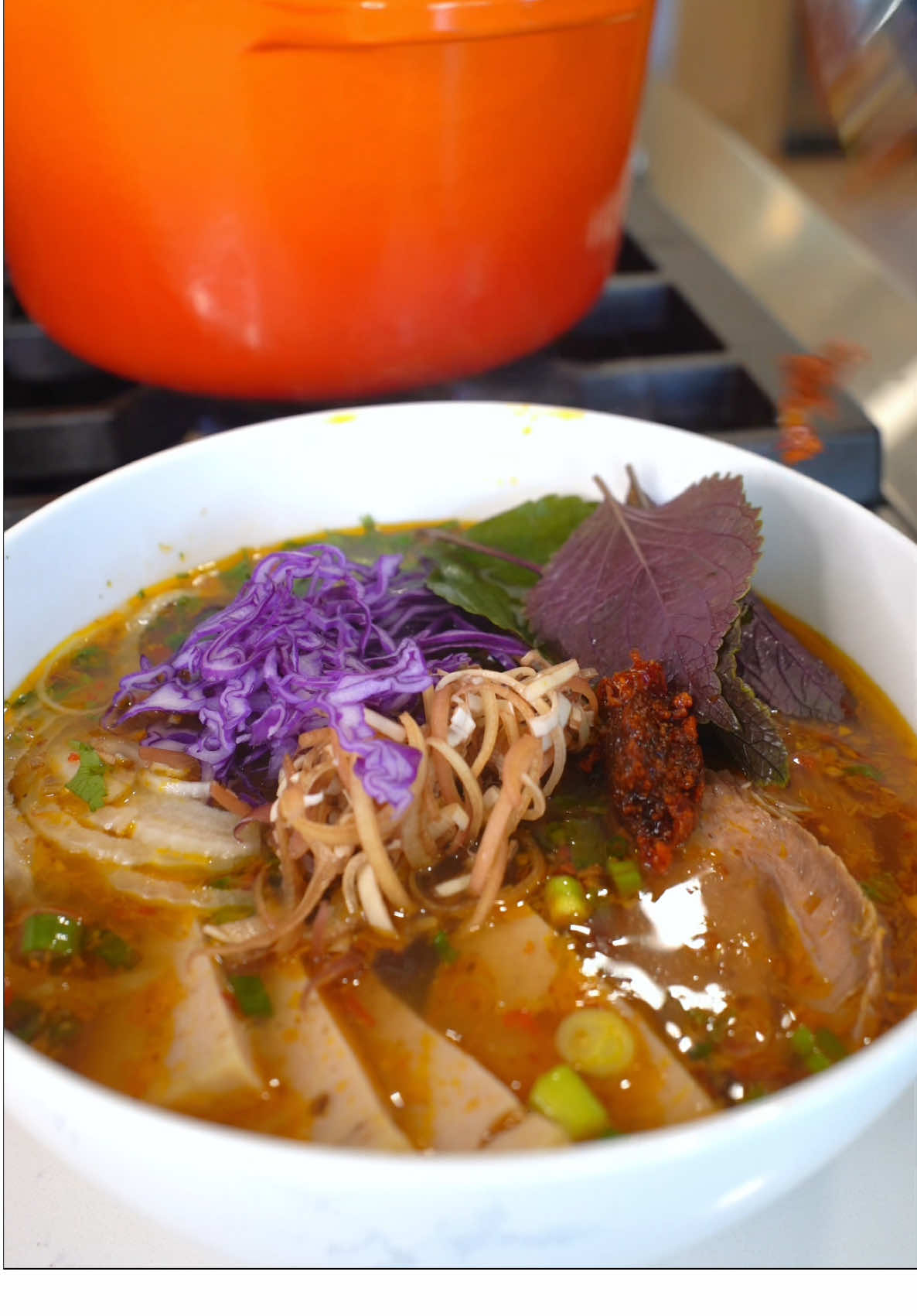 BUN BO HUE (PART 1/2- THE BROTH) I’m sorry this had to be a multiple part series @jaimeeandfamily  3 lbs beef bones 3 lbs pork bones 2-3 lb beef shank 2-3 lbs pork hock 1 onion 7-8 stalks of lemongrass 2 large knobs of ginger The core of 1 pineapple + ¼ of a pineapple* 3 golf ball size rock sugar 10 quarts of water TO SEASON: Salt Shrimp paste Sugar Fish sauce Chicken bouillon MSG 1. PARBOIL YOUR BEEF AND PORK: in a large stock pot, add beef bones, pork bones, beef shank and pork hock. Fill this with water and bring to boil. Once boil, leave it to boil for 3-5 minutes. After 3-5 minutes, pour your beef and pork through a strainer. Rinse your beef and pork off if any gunk/ impurities. Wash youtr stock pot if you plan on using the same one to make your soup.  2. While your beef and pork was parboiling, prep the rest of your ingredients. - onion: peel it the skin, leave it whole - lemongrass: cut off the leafy end and discard. Cut the black/ brown tip off your lemongrass. Peel the first 1-2 layers of lemongrass. Using a mallet or spine of your knife, bruise lemongrass so the aroma can be easily released into your broth. Cut lemongrass in ½ or 1/3 - ginger: peel ginger using a spoon—it’s the fastest and easiest way 3. Now the fun part, add everything into your stock pot: parboiled beef and pork bones, parboiled beef shank, parboiled pork hock, onion, ginger, pineapple, lemongrass, rock sugar and 10 quarts of water. B ring this to a boil. Once boiling, reduce heat and simmer for at least 6 hours. While you simmer, there will be some scum/ impurities that float to the top, make sure to scoop it out. Halfway through simmering, refill with water. Time stamps to remember: - 2 hours: remove ginger, onion and pork hock. - 3-3.5 hours: remove beef shank. Leave this to cool before slicing 4. When your broth is done simmering, discard everything that is inside (bones, pineapple, etc). then pour your broth through a strainer. Add chili oil to your broth (ill have a video on this posted next). After you’ve added chili oil, then season to preference. I season with salt, shrimp paste, sugar, fish sauce, chicken bouillon and/or MSG.  5. Once you are done with your broth, assemble a bowl.
