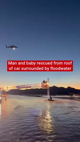 A man and a baby, who were sitting on top of their vehicle in a flooded roadway in Arizona, were rescued by search and rescue personnel from the Pinal County Sheriff's Office. 
