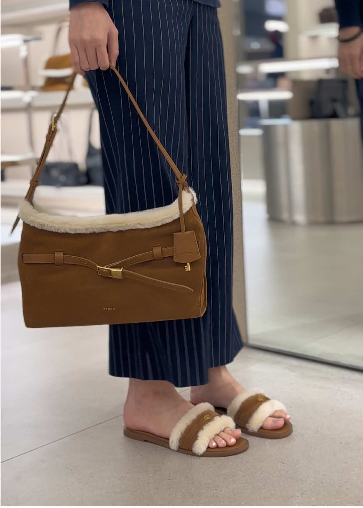 The Shoulder Bag reworks classic design codes through a softer, more fluid lens. Its slouchy calf leather construction brings a sense of ease, contrasted by a structured belt accent that cuts clean across the body of the bag. Branded hardware and a magnetic closure keep the details minimal but intentional. #pedroshoes_official #pedroterminal1 #shoulderbag #leatherbag #trending 