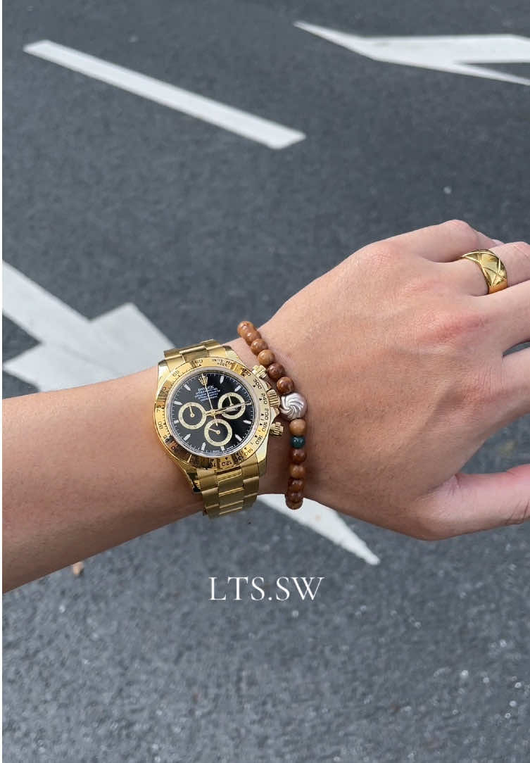 “Rolex Yellow Gold Black Dial Daytona: The Black Samurai of Timepieces” There’s a piece that transcends mere horology—it’s a statement, a legacy, and a blend of raw power with refined elegance. Meet the Rolex Yellow Gold Black Dial Daytona, affectionately dubbed the “Black Samurai” by enthusiasts. Crafted in 18k yellow gold, its case and bracelet exude a timeless luxury that ages like fine wine. The black dial, a canvas of precision, features three sub-dials that pulse with the rhythm of speed and accuracy—true to the Daytona’s racing heritage. When light hits it, the contrast between the gold’s warmth and the dial’s depth is nothing short of mesmerizing. Wearing it isn’t just about telling time; it’s about owning a piece of horological art that balances boldness and sophistication. Whether paired with a tailored suit or a casual ensemble, the “Black Samurai” commands attention, whispering tales of craftsmanship and legacy with every glance. For those who seek a watch that’s as fierce as it is refined, this Daytona is more than an accessory—it’s a companion for life’s grand journeys, a symbol of achievement, and a testament to the idea that true luxury is both powerful and timeless. #luxury #luxurywatches #watch #rolex #daytona 