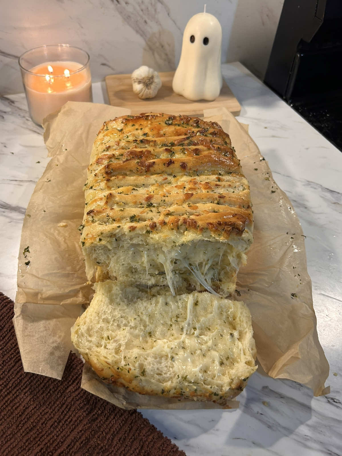 cheesy garlic pull apart bread!! so soft & cheesy 🤎   recipe: ¾ cup warm milk (180g) 2 tbsp sugar (25g) 2¼ tsp instant yeast (7g) 1 large egg (50g)(rt) ¼ cup softened butter (57g) 1 tsp salt (6g) ½ tsp garlic powder (2g) ½ tsp onion powder (2g) 3 cups all-purpose flour (375g)  mix the warm milk, sugar, and yeast and let it sit until foamy. add your egg and butter, then mix in the dry ingredients until a soft dough forms. knead until smooth, about 8–10 minutes, then cover and let rise somewhere warm until doubled in size (about 1 hour). garlic butter filling : ¼ cup butter (57g) 2 cloves minced garlic or ¾ teaspoon garlic powder (6g or 2g) 1 tbsp chopped parsley or 1 tsp dried parsley (4g or 1g) ¼ cup grated parmesan (25g) pinch of salt (1g)   melt your butter. combine the butter, garlic, parsley, and salt. (i let it simmer together a bit to get extra flavor into the butter!) roll your dough into a rectangle, spread the butter mixture evenly, and sprinkle the cheeses on top. cut the dough into 3 even strips, stack them, then cut again into squares and layer into your pan. let it rise again for 30–40 minutes. cheese layer : 1 cup mozzarella(110g) 1/2 cup pepperjack(55g) & 1/4 cup parmesan (25g) ( use wtv cheese you want but i found pepperjack really makes it soo flavorful ! )   topping (after it’s baked) 2 tbsp melted butter (28g) 1 clove minced garlic (3g) ½ tsp parsley (1g) 2 tbsp grated parmesan (12g) after baking at 350°F (175°C) for about 25–30 minutes or until golden, brush the bread with melted butter, garlic, parsley, and parmesan. serve warm. (if your rolls start to brown too fast tent with foil until they’re finished baking :) ) #garlicbread #cheese #bread #baking #fyp  