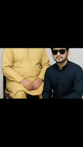 Convert this image into ultra 8k realistic photo of 2 guys (take reference face as uploaded images face of first image 100%), seated on a wooden chair with straight, and guy 2 (take reference face as uploaded slim face of second image 100%) sits on the floor beside him wearing same dress, the faces both guys faces should be 100% matched as in both reference photos 1 and 2