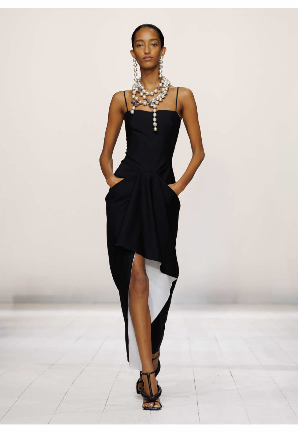 Mona wears the sliced wrapped dress in black wool mohair and white cotton poplin with spiky pearl jewellery and boudoir thong sandals.  Givenchy by Sarah Burton  #monatougaard 