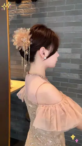 Lotus-claw clip: petals bloom quietly above your nape, golden tassels drip like morning dew and chime with every step. Oversized spring grip locks in the thickest hair; lift your head and soft light kisses your profile. Office-day gentle, date-night ethereal—clip once, become the white-moonlight memory.#hairband #hairstyle #cilp #tiktok #beautiful #fyp 