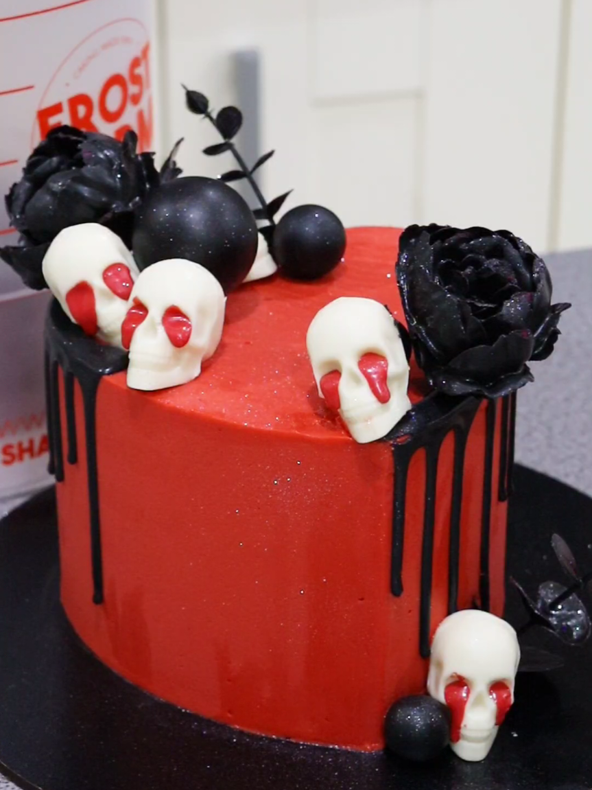 Skull drip cake! Soften your buttercream for easy piping and minimal air bubbles 😊 6 inch heart frost form kit and colourmill drip from frostform.com- use code FROSTLOVE10 for a discount at frostform.com checkout  #halloweencake #heartcake #skullcake #redcake #buttercreamcake 