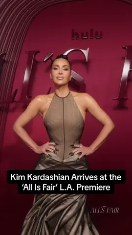 #KimKardashian did what she does best—made an entrance. The star stepped out to the 'All Is Fair' L.A. premiere in a structured Schiaparelli gown.