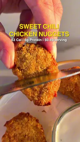Recipe below 👇 SWEET CHILI CHICKEN NUGGETS Makes 20 Nuggets Per Nugget: 63 Calories | 6g Protein | $0.45 Ingredients 1 lb / 453g ground chicken 1x / 50g large egg ½ cup / 60g cornstarch 1 bag / 32g Quest protein chips ½ cup / 40g grated Parmesan cheese Garlic powder, onion powder, paprika, salt, black pepper Directions 1. Blend the Quest protein chips to a fine powder. 2. In a bowl, combine blended chips, cornstarch, and grated parmesan. 3. In a 2nd bowl, combine the ground chicken, egg, garlic powder, onion powder, paprika, salt, and pepper. Mix with your hands until just combined. Do not overmix. 4. Lightly wet your hands to prevent sticking, then shape the chicken mixture into ~20 nugget shapes (about 1.5 tbsp each). Place them on a parchment-lined tray. 5. Roll each nugget directly in the breading mixture, pressing gently to ensure an even, thick coating on all sides., 6. Lightly spray nuggets with cooking spray and air fry at 390°F (200°C) for 10-12 minutes. 7. Let the nuggets rest for 2 minutes before serving. Serve with your favorite sauce.