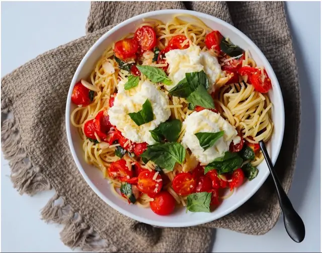 In honor of #nationalpastaday, here is one of the blog’s most popular recipes: This simple, classic Italian dish is a hit no matter what time of year! Ingredients: 2 cloves of garlic container of cherry tomatoes 3 basil leaves 3 teaspoons of olive oil One box of spaghetti  ½ cup of vegetable broth ½ cup of parmesan cheese ½ cup of ricotta cheese salt + pepper to taste Instructions: Bring a large pot of salted water to a boil. Peel and mince garlic. Cut cherry tomatoes in half. Combine 1 teaspoon of olive oil, salt, and pepper. Remove basil leaves from stem, chop leaves. Add spaghetti to boiling water and cook according to spaghetti package directions. Drain spaghetti. Heat two teaspoons of olive oil in a pan.  Add garlic and stir/cook for two minutes.  Season with salt and pepper. Add vegetable broth, ½ cup of water, and bring mixture to a simmer. Stir in cherry tomatoes into sauce.  Add ¼ cup of parmesan cheese, mix to combine.  Add basil and season with salt and pepper, turn off flame. Prepare dish by putting spaghetti on dish, top with parmesan cheese (and optionally, with ricotta).
