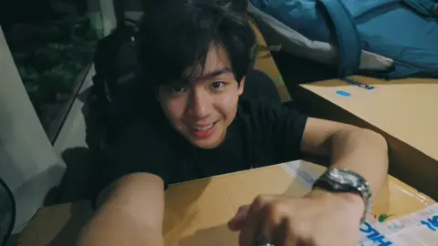 #POV 2: Part 20 “My MVP” The morning they were set to leave, the air smelled of brewed coffee and sea salt. The sun had barely risen, but the whole house was already awake. Tita Janice was in the kitchen, humming as she wrapped snacks in brown paper bags. Astrid sat cross legged on the couch, pouting. “Kuya, bakit ang bilis niyo umalis?” she mumbled, chin propped on her palm. “Akala ko two weeks kayo dito.” Astrid said Jeo laughed, ruffling her hair. “Kung wala lang kaming game, I’d stay.” “Lagi na lang may game,” she grumbled. “Ate, you’ll come back, right?” I smiled and knelt in front of her. “Of course. Baka next time, sabay na tayong mag braid ng hair.” Her face lit up instantly. “Promise?” “Promise.” Alona said. From behind us, Tita Janice called out, “Oh, Alona, I packed some dried mangoes for you. And para kay mama mo rin.” “Salamat po, Tita.” She smiled warmly. “I’m happy you came, ija. You made this house livelier.” I didn’t know how to respond to that, so I just gave her a tight hug. She smelled like jasmine and morning air comforting and familiar. Outside, Jeo was loading their bags into the car, his shirt damp from the humidity. When he looked up and saw me watching, he smiled that easy smile of his the one that made it hard to think straight. “Ready?” he asked. I glanced back at the beach house the blue walls, the wind chimes, Astrid waving through the window. “Ready” said. The ride to the airport was quiet, the kind of silence that didn’t need words. The sea shimmered in the distance, the same sea that had felt like home just the night before. At the terminal, Jeo handed her boarding pass, his fingers brushing against mine. “You okay?” he asked. I nodded. “Just… not ready to go back to reality yet. I love it here” Alona said. He chuckled softly. “Reality’s not so bad. I’ll still be there.” “Yeah, but exams will be too” Isaid, rolling my eyes. He laughed, the sound light and familiar. “Fine. After the game, we’ll plan another break. Maybe somewhere closer this time.” I raised an eyebrow. “Closer, meaning…?” He smirked. “Batangas? Or, you know, your favorite coffee shop across campus.” I nudged his arm. “That’s more like it.” When the plane took off, I looked out the window one last time. The ocean faded into clouds, and soon, the islands disappeared completely. Jeo leaned his head back, eyes closed, earphones in. But his hand found mine between the seats, fingers intertwining. “Next stop,” he murmured without opening his eyes, “home.”  I looked at him his lashes, his steady breathing, the faint smile at the corner of his lips and thought, maybe home follows you wherever you let it. By the time they landed in Manila, the city had already sunk into its usual rhythm cars honking, people rushing, the air thicker with noise and movement. But even as we stepped out of the terminal, dragging our bags and heading straight for the waiting van to take him to the arena, I realized something. I didn’t feel the weight of leaving anymore. Because somewhere between the long drives, late night laughter, and quiet porch talks, I had stopped feeling like an outsider in his world. And as Jeo turned to me one last time before heading into the arena, grinning like he always did before a game, I just smiled back and said, “Play well, okay?” He winked. “Always do when you’re watching.” And just like that, we were back to the noise, but somehow it didn’t feel loud anymore. #jeremiahong #jeoong #pov #au 