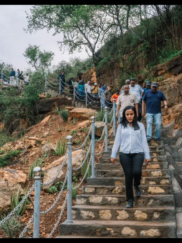 የባሌ ዞን የመጀመሪያ ቀን ጉብኝት ያሳየን በድንቅ ተፈጥሮ እና በልማት ሥራ እድገት መካከል ያለውን መስተጋብር ነው። በአስደናቂ ብዝኅ መልኩ የባሌ ተራሮች ብሔራዊ ፓርክ የቱሪዝማችን አንዱ የማዕዘን ድንጋይ ሆኖ ቀጥሏል። ይኽ እምቅ አቅም በፓርኩ እምብርት ላይ የተገነባው የዲንሾ ሎጅ በቅርቡ ሲጠናቀቅ የበለጠ ይጠናከራል። በአቅራቢያው በመገንባት ላይ ያለውና በቅርቡ የሚጠናቀቀው የሶፍኡመር ሎጅ ቱሪዝምን የኢኮኖሚያችን ቁልፍ መሪ አድርጎ ያስቀመጠው የኢትዮጵያን የ10 አመት ስትራቴጂክ እቅድ የሚተገብር ነው። ሎጁ በሶፍኡመር ዋሻ የጎብኝዎችን ቆይታ ከፍ የሚያደርጉ እና የመዝናኛ አገልግሎት መስጫዎች በሶፍኡመር ዋሻ ልማት ፕሮጀክት እገዛ የሚዘጋጁበት ነው። በመንገድ መሠረተ ልማት ረገድ የሮቤ-ጎሮ-ሶፍኡመር-ጊኒር መንገድ የማሻሻያ ፕሮጀክት ከፍተኛ አምራች የሆኑትን የምሥራቅ ባሌ እና የባሌ ዞኖችን ምርታቸውን ከማዕከላዊ ኢትዮጵያ የሚያገናኝ ነው። ይኽ መሥመር ተደራሽነትን እና የኢኮኖሚ ተያያዥነትን ብቻ ሳይሆን እንደሶፍኡመር ዋሻ እና የባሌ ተራሮች ወደ መሰሉት ዐበይት የመስኅብ ሥፍራዎች ጉዞን የሚያሳልጡ ናቸው። ድርብ አስፋልት ንጣፍ ባለው ከፍ ያለ ደረጃ የተገነባው መንገድ 29 ኪሎሜትር የከተማ እና የገጠር መንገድን የሚያካትት ብሎም ከ12 እስከ 140 ሜትር ርዝመት ያላቸው አምስት ድልድዮች የተሠሩበት ነው።  የቀኑን ጉብኝታችንን የወይብ ወንዝ የጎርፍ መቆጣጠሪያ ፕሮጀክትን በመመልከት አጠናቀናል። ፕሮጀክቱ በሶፍኡመር ዋሻ የሚጓዘውን የወንዙን የውሃ ፍሰት በመቆጣጠር አመቱን ሙሉ ወደ ዋሻው የሚደረግ ጉዞ እንዳይስተጓጎል ለማድረግ ብሎም የዋሻውን ሥነምኅዳር ለመጠበቅ ታልሞ የተሠራ ነው። ሁሉም ሥራዎች ቀጣይነት ላለው ልማት ያለንን ጽኑ አቋም እና ተግባር የሚገልጡ ናቸው። Day one in the Bale Zone has shown us the powerful nexus between natural wonders and development progress. The Bale Mountains National Park, with its remarkable diversity, continues to be one of the cornerstones of our tourism pillar. This potential will soon be strengthened by the completion of the Dinsho Lodge, located at the heart of the park. While nearby, the Sof Omer Luxury Lodge, now nearing completion, is designed to advance Ethiopia’s Ten-Year Strategic Plan by positioning tourism as a key driver of economic growth. The lodge will elevate visitors’ experiences at the Sof Omer Cave,  offering premium accommodation and leisure facilities and is complemented by the Sof Omer Cave Development Project. In the realm of road infrastructure, the Robe–Goro–Sof Omer–Ginir Junction Road Upgrading Project plays a vital role in linking the highly productive agricultural zones of East Bale and Bale with central Ethiopia. This connection not only improves accessibility and economic integration but also facilitates travel between major attractions such as the Sof Omer Cave and Bale Mountains National Park. Built to high standards with dual asphalt concrete layers, the project covers 29 kilometers of urban and rural roads and includes five bridges ranging from 12 to 140 meters in length. We concluded the day with a review of the Weib River Flood Control Project, which aims to regulate water flow inside the Sof Omer Cave, ensuring year-round accessibility and safeguarding the cave’s ecosystem. Together, these initiatives reflect our unwavering commitment to sustainable development.#prosperity #AbiyAhmed #PMOEthiopia #Oromia #shimalis_abdisa 