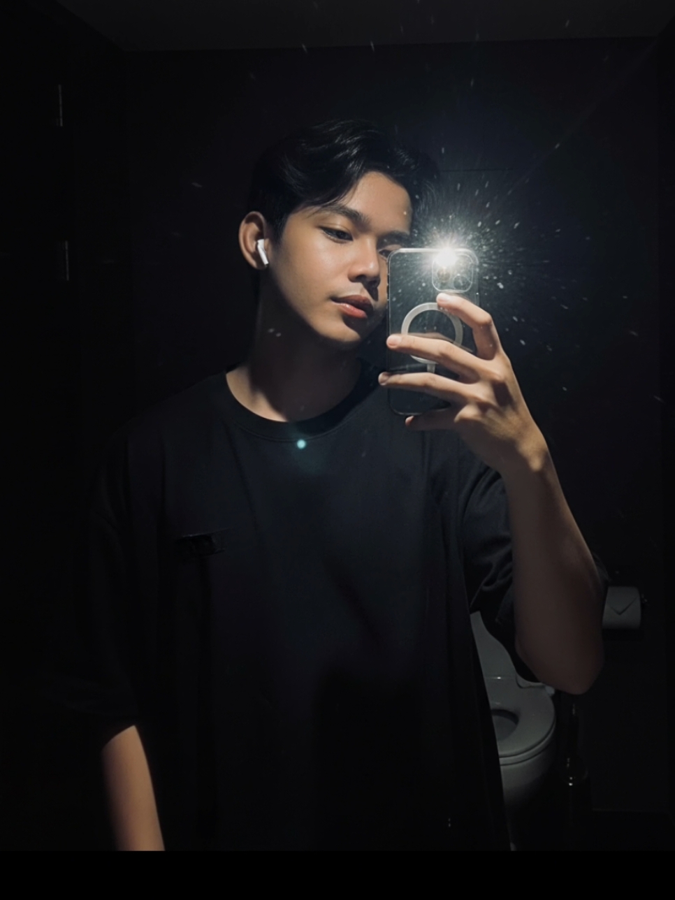 CR MIRROR SELFIE PROMPT Create my image in taking a mirror selfie in a dark restroom, only illuminated by the camera flash, wearing a loose black t-shirt, holding a smartphone with one hand, short slightly wavy black hair styled naturally, wearing white wireless earbuds, subtle confident expression, realistic human proportions, harsh light from flash reflecting on mirror and face, dark background with minimal visibility, cinematic shadows, dramatic lighting contrast, realistic reflections and light flares from the flash, detailed skin texture, glossy mirror surface, casual urban mood, ultra realistic photography, 4K resolution, professional DSLR, 50mm lens, f/1.8 aperture, ISO 400, photo aspect ratio 9:16, low light realism, high contrast aesthetic Figure 2 : insert the photo I uploaded into the prompt below, a young man standing in front of a mirror in a dark restroom, one hand in pocket and the other holding the phone for a mirror selfie, looking slightly away from the mirror, only illuminated by camera flash, soft flash reflection on mirror and face, loose black t-shirt, messy slightly wavy black hair, white earbuds, cinematic low light, moody atmosphere, realistic lighting and reflections, ultra detailed skin texture, dark minimalist background, professional DSLR shot, 50mm lens, f/1.8, ISO 400, 4K photo realism, aspect ratio 9:16 Figure 3 : insert the photo I uploaded into the prompt below, a young man taking a mirror selfie in a dark room, head tilted slightly down, face partially illuminated by bright camera flash, wearing a loose black t-shirt and white wireless earbuds, holding phone close to face, realistic light burst reflection, cinematic low key lighting, dark minimal background, subtle expression, sharp focus on face and hand, realistic texture and shadow depth, 4K ultra realistic photo, professional DSLR, 50mm lens, f/1.8, ISO 400, photo aspect ratio 9:16 #geminiai #googlegemini #ai #prompt #trendingai #fypシ゚ #trending 