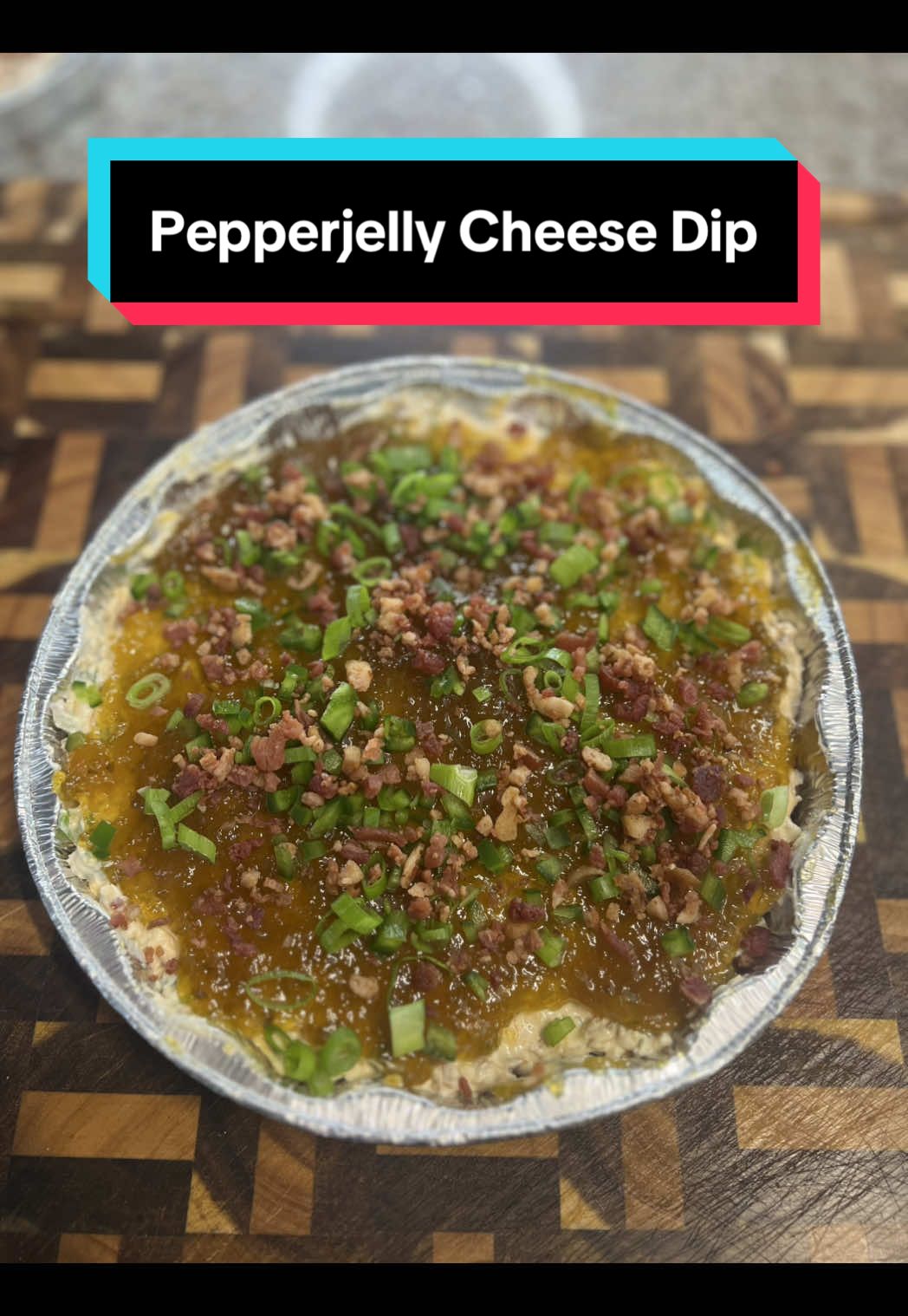 Pepper Jelly Cheese Dip! Ingredients: Jalapeños - 2 Green Onion - 1 bunch  Melinda’s Pineapple Jalapeño Pepper Jelly  Pepper Jack Cheese - 4oz Sharp Cheddar Cheese - 4oz Whipped Cream Cheese - 12oz Sour Cream - 8oz Bacon Bits - 1c+ Garlic Powder Smoked Paprika  Slap Ya Mamma Seasoning  Directions: 1. Start by finely dicing the jalapeño, slicing the green onions and shredding the cheese. You can always use pre shredded cheese as well.  2. Add the cream cheese, sour cream and about 1/3c of the pepper jelly to a large bowl. Then pour on the jalapeños and green onions saving some for the top of the dip. Add one cup of bacon bits, the shredded cheese and some garlic powder, smoked paprika and slap ya mamma seasoning.  3. Give everything a good mix until it is smooth. Add to your dish and spread out the rest of the pepper jelly on top in an even layer. Top with the remaining jalapeños, green onions and some more bacon bits. I like to serve it with some ritz crackers. Enjoy! #pepperjellydip #pepperjelly #cheesedip #dip #gamedayfood 