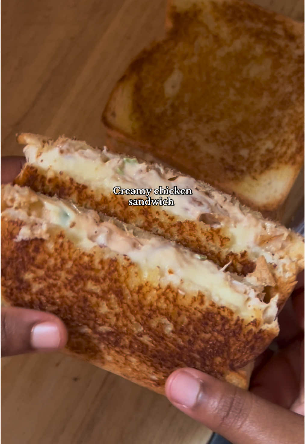 Creamy chicken sandwich. Ingredients: -Marinated chicken breast in spices of your choice cooked in an air fryer. Shred it. -small chopped bell red pepper  -green bell pepper. -red onion -fresh corriander leaves -mayonnaise  -ketchup -paprika powder -black pepper powder -garlic powder  -mozzarella cheese  -slices of bread  -butter for toasting the bread . Enjoy!!! #foodtiktok #fyp 