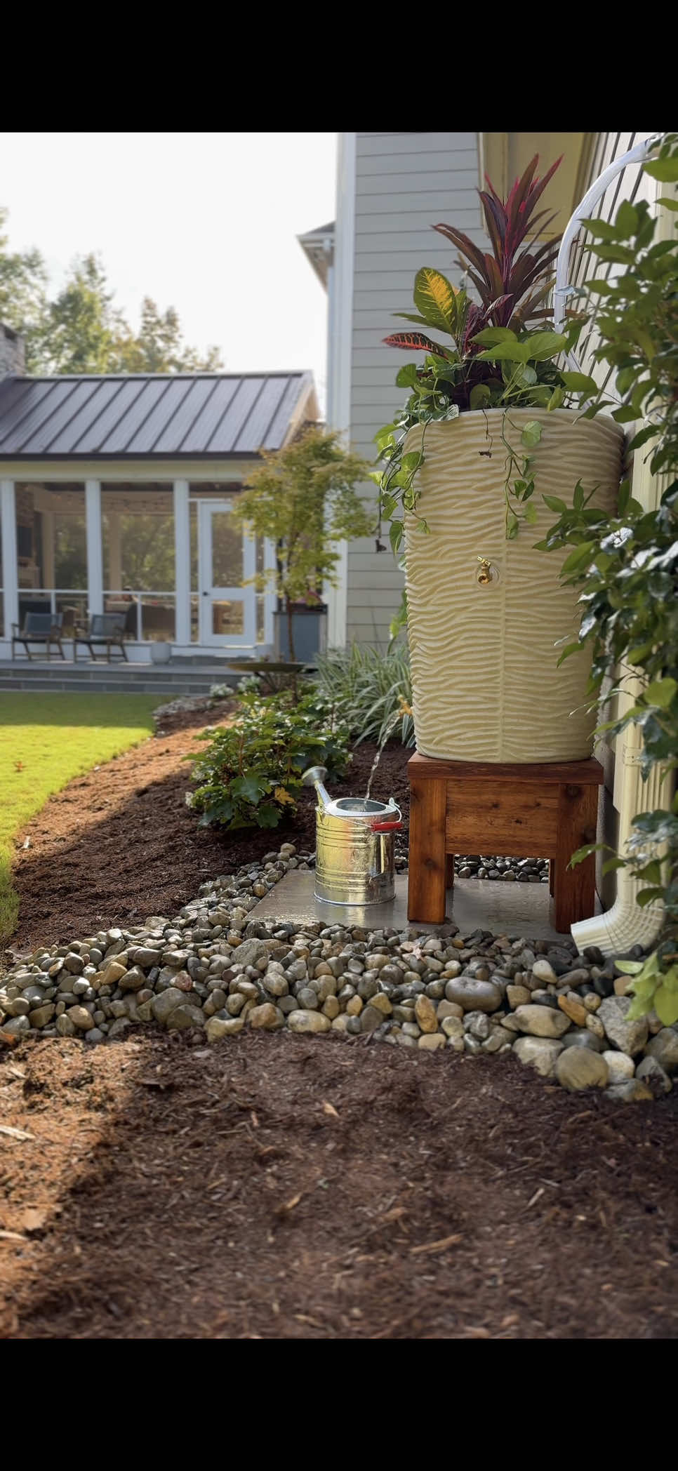 Reveal at the end! I think my favorite part is the porcelain bluestone tile addition, let me know if you think you’d try this one, in the comments! #rainbarrel #backyard #landscaping 