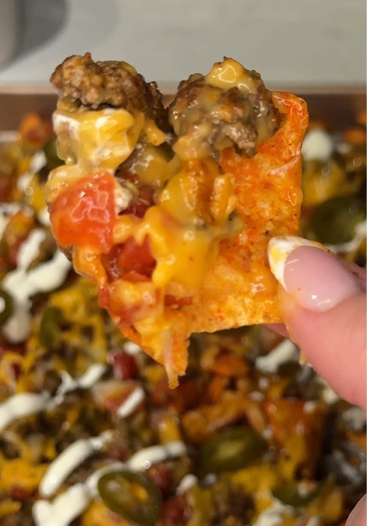 the viral sheet pan nachos are even better with doritos 🔥 Ingredients: 1 bag spicy nacho @Doritos  1 lb ground beef (cooked and drained) 1 taco seasoning packet 1 can mild rotel tomatoes 1 can nacho cheese 1 cup shredded Mexican cheese sour cream and jalapeño slices, (optional toppings) Instructions: On one sheet pan, spread out full bag of doritos. On a second slightly smaller sheet pan, pour and spread the nacho cheese evenly. Top the cheese with cooked ground beef, sprinkle with taco seasoning, add tomatoes, and finish with shredded cheese. Bake at 350° for 15–20 minutes until hot and melty. Pour the cheesy beef mixture over the Doritos, drizzle with sour cream, and top with jalapeños. Serve immediately and enjoy! 😋 #nachos #doritos #snacks #Recipe #creatorsearchinsights 