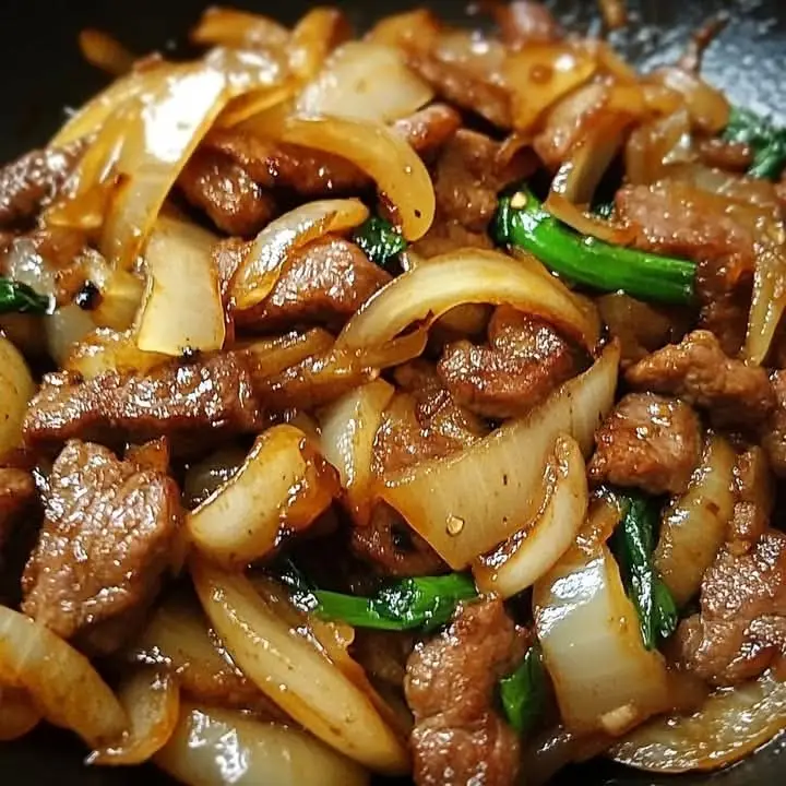 Chinese Pepper Steak with Onions Ingredients: For the Beef: 1 lb (450 g) flank steak or sirloin, thinly sliced against the grain 2 tbsp soy sauce 1 tbsp cornstarch 1 tsp sesame oil For the Stir-Fry: 2 tbsp vegetable oil 1 large onion, sliced 1 green bell pepper, sliced 1 red bell pepper, sliced 3 cloves garlic, minced 1-inch piece fresh ginger, minced For the Sauce: 1/4 cup soy sauce 2 tbsp oyster sauce 1 tbsp hoisin sauce 1 tsp sugar 1/2 cup beef or chicken broth 1/2 tsp black pepper 1 tsp cornstarch mixed with 2 tsp water (slurry) Instructions Marinate the Beef: In a bowl, combine sliced beef, 2 tbsp soy sauce, 1 tbsp cornstarch, and 1 tsp sesame oil. Toss to coat and let sit for 10–15 minutes. Prepare the Sauce: In a small bowl, mix soy sauce, oyster sauce, hoisin sauce, sugar, broth, and black pepper. Set aside. Stir-Fry the Beef: Heat 1 tbsp vegetable oil in a large skillet or wok over high heat. Add beef and stir-fry for 2–3 minutes until just browned. Remove beef and set aside. Cook the Vegetables: In the same skillet, add remaining 1 tbsp oil. Sauté onions, green and red bell peppers, garlic, and ginger for 3–4 minutes until tender-crisp. Combine & Thicken: Return the beef to the skillet. Pour in the prepared sauce and stir to combine. Add cornstarch slurry and cook for 1–2 minutes until sauce thickens and coats the beef and vegetables. Serve: Serve hot over steamed rice or noodles.